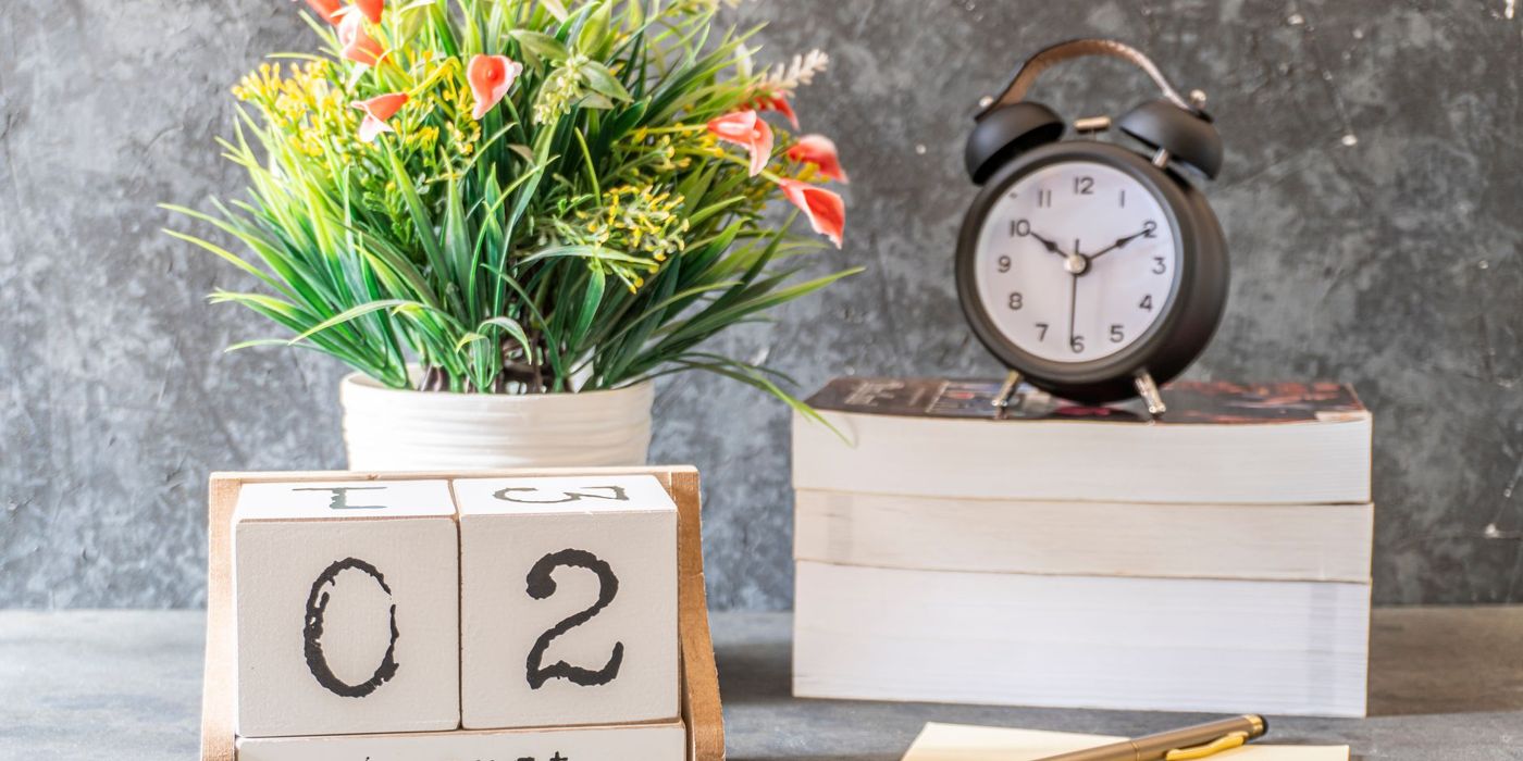 A calendar and clock on a desk