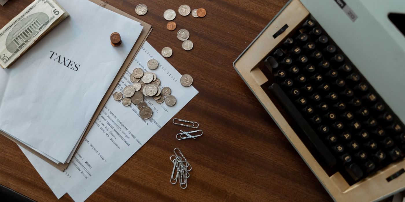 A calculator with coins and documents