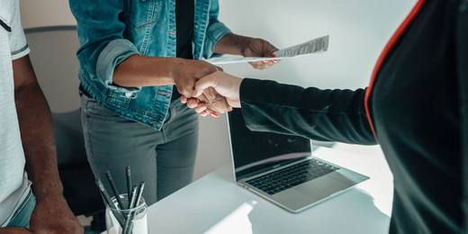A handshake over documents