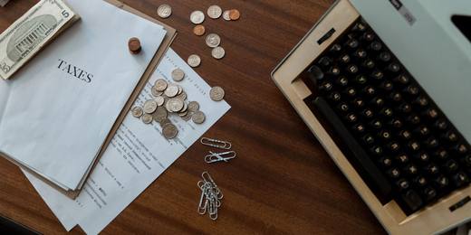 A calculator with coins and documents