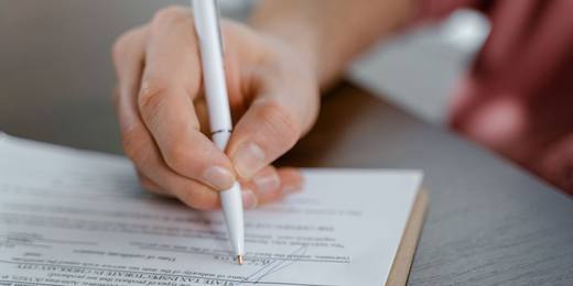 Signing a legal document with a pen